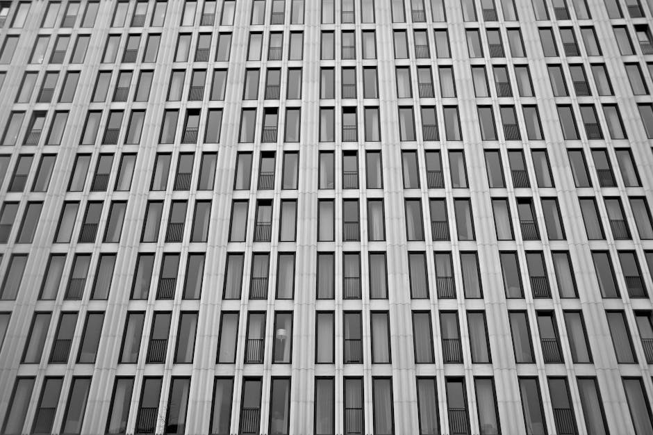 Modern corporate skyscraper windows representing architectural financial stability